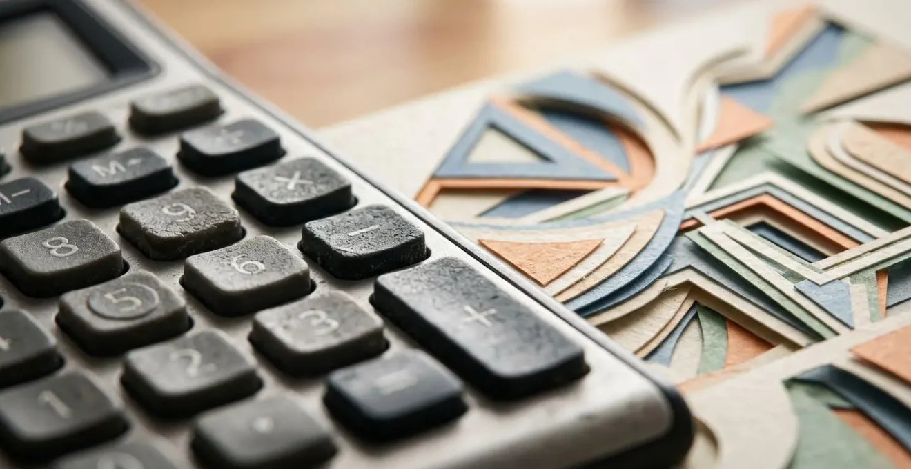 Close-up of financial calculator and abstract data patterns on desk