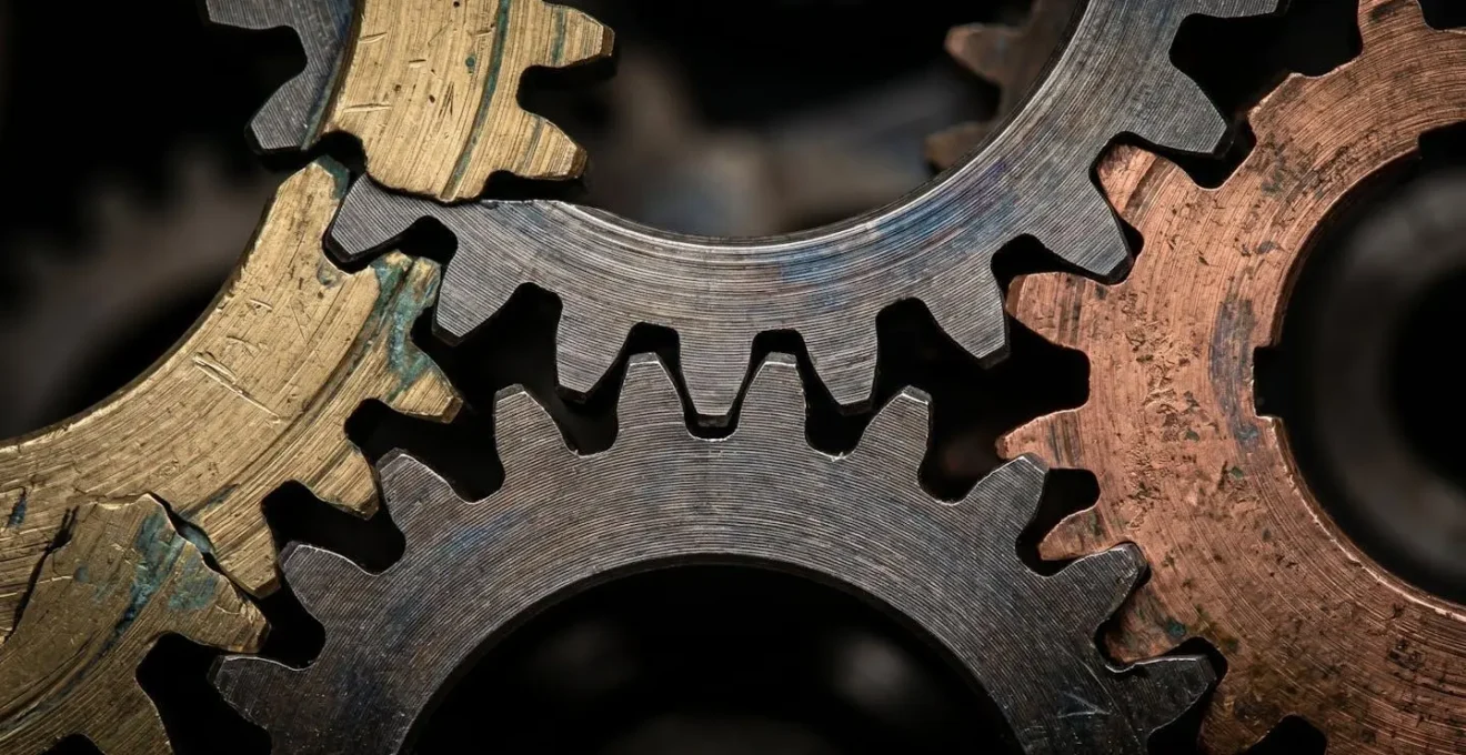 Interlocking metallic gears representing the different, balanced components of a strategic compensation portfolio.